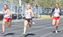 Abby Holmes and Aubree Miller run hard in the 100m sprint. (Photos by Madi Graber, Ella Sperl, and Maya Hull)