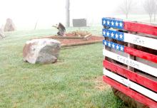Wooden American Flag and eagle decorate the Martinmaas farmyard. Even though he sustained life-altering injuries, Polo farmer, Ray Martinmaas said his time of service strengthened his love of and respect for his country. (Photo by SDFU)