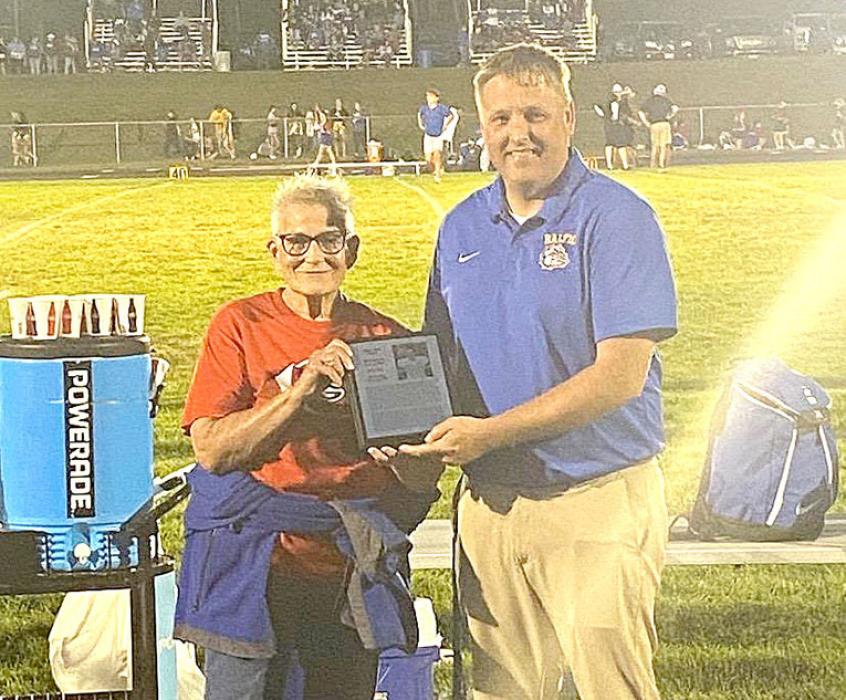 Coach John King’s mother, Rita, accepted his award in his absence at the Baltic High School’s Homecoming game on Friday, September 14. 2024.