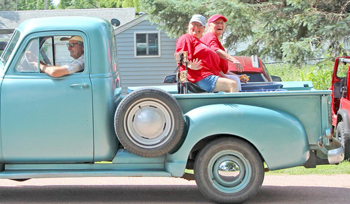 Marcy Creekmur (l) and Marlene Rezac were the parade marshals. Harold Winters won first place in the antique tractor division.