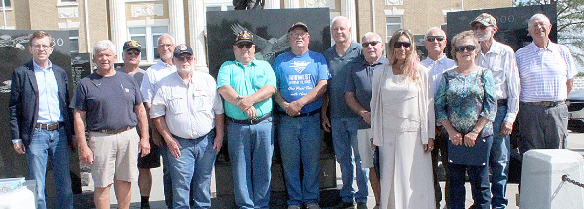 Congressman Dusty Johnson held a Vietnam veteran commemorative ceremony on August 3, 2023, at the Veterans’ memorial at the Tripp County Courthouse in Winner, SD. Pictured from left to right were Congressman Dusty Johnson, Vernon Witt, Michael Clinch, John Knight, Dan Walker, Richard Vakiner, Glen McCready, Doug Long, Jack Burns, Betty Jeffords accepting for Larry Hargis, Greg Biggins, Barb Matucha accepting for her husband Dennis, Ray Yeager, and Tony Berg. (Photo by Dan Bechtold/Winner Advocate)