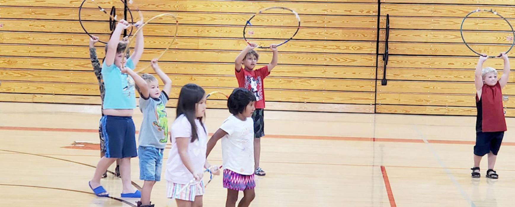 Several children volunteered to join Starr Chief Eagle to try some hoop dancing moves.