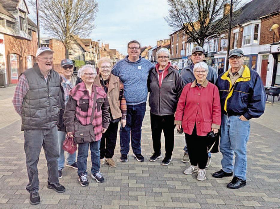 Nine of the travelers stop for a photo in the street in Stratford upon Avon where Shakespeare was born. (Submitted photo)
