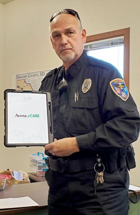 Police Chief Doug Catts shows the iPad that his department will use in crisis situations to connect individuals with qualified mental health professionals.