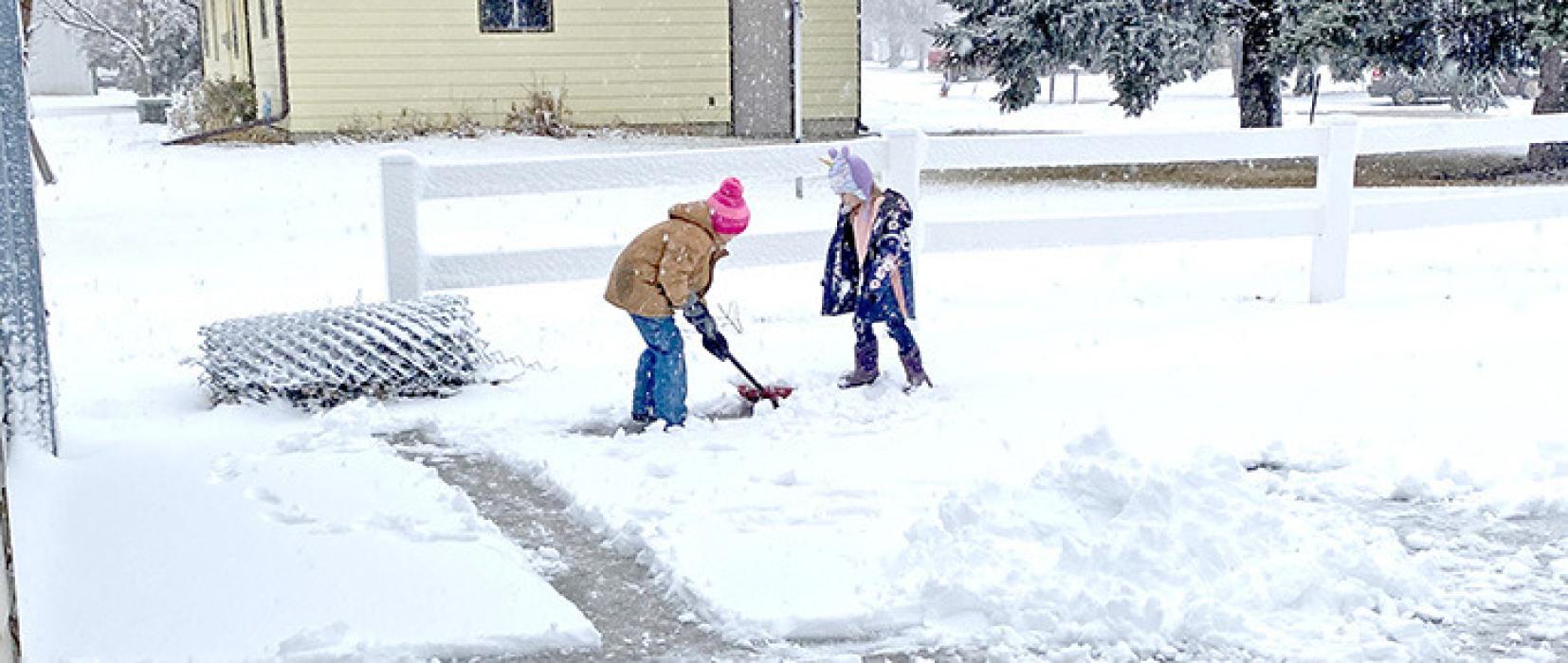 Young area residents getting an early start on future sidewalk scooping venture.