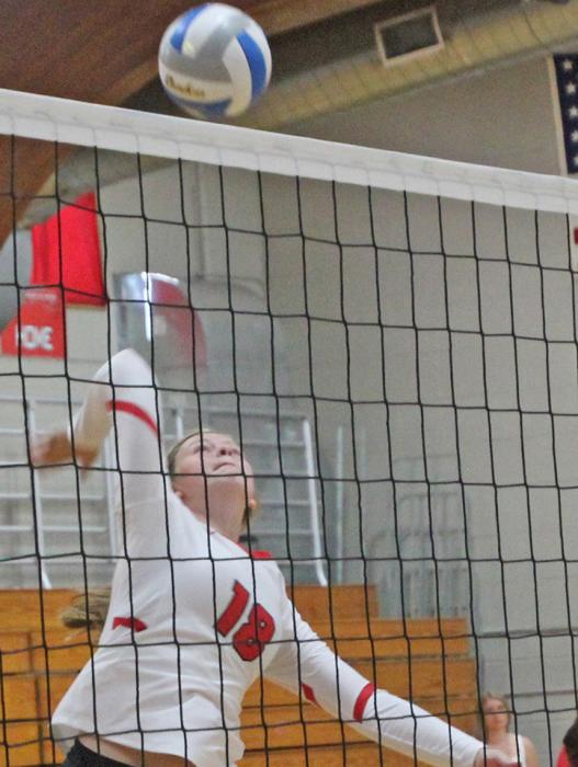 Cassity Keiser, top and Mia Determan, bottom, played hard at the net as Gregory placed third in their annual host tournament.