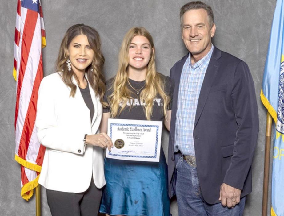 Governor Kristi Noem, left, and ASBSD President Eric Stroeder, right, presented Dakota Timanus, center, the Academic Excellence Award during a luncheon held on Monday, May 9, 2022.