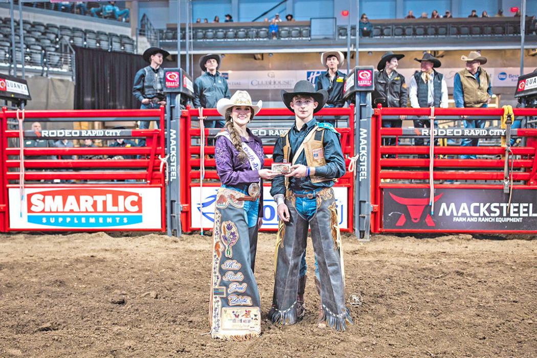 Taos Weborg accepts a buckle for winning the bareback event at 20X at the Black Hills Stock Show earlier this month. (Submitted photo)