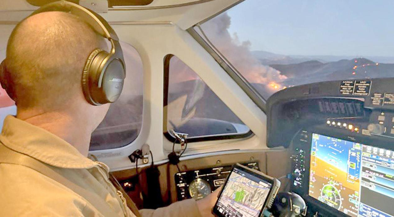 Dave Mundwiler, a lead plane pilot, flies a recent mission in the lead wildfire response plane. In the airspace around wildfires, large airtankers, helicopters, water scoopers all share the same airspace. When unknown drones are spotted all of this activity is grounded due to safety reasons. (Forest Service photo by David Mundwiler)