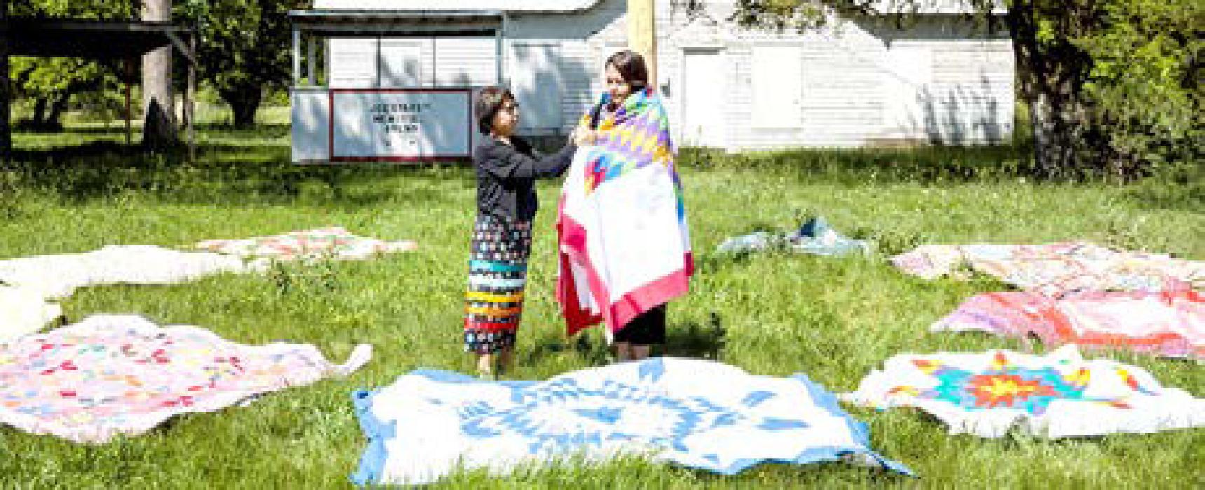 Wilma had given away all of her finished quilts when the magazine crew arrived to interview her, so they laid out her completed tops on the grounds at Milks Camp for a photo. (Photo from Quiltfolk, used with permission)