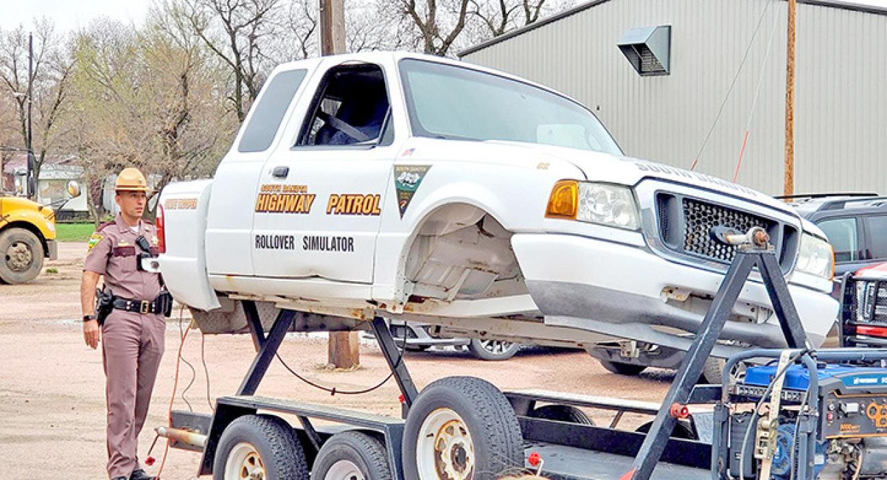 Sgt. Ryan Lantz of the South Dakota Highway Patrol brought the rollover simulator to show students how a seat belt will keep them from falling out of a vehicle in the event of a rollover accident.