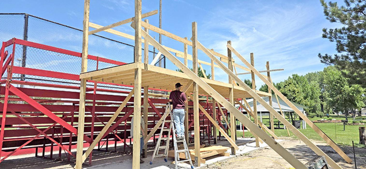 Dylan Fiebelkorn, part of Joe Klein’s construction crew, works on a new crows nest at the city ballpark. The project is a Brian Anderson memorial. Ground breaking for the new crows nest was held last July, and the dedication will be held at a later date. The plan is to have the structure completed by the Jr. Teener State Tournament, July 24-26, which Gregory will host.