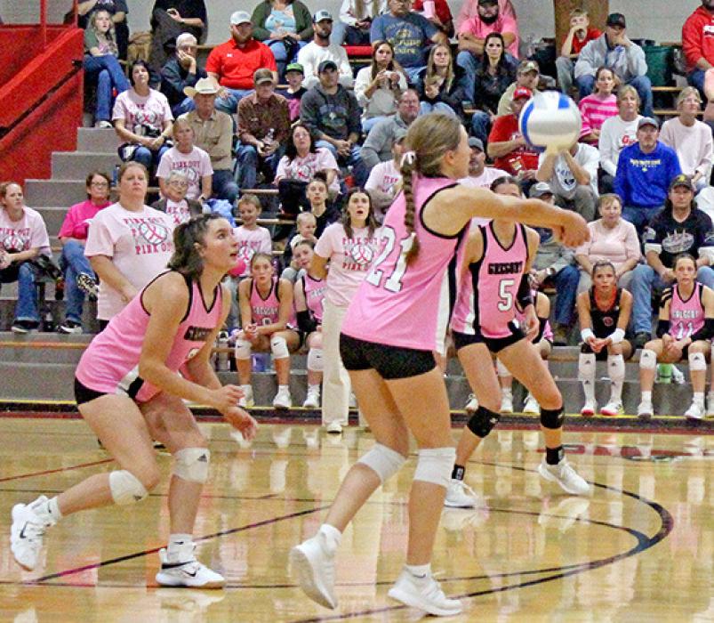 Adelyn Veskrna, #21, bumps the ball as Shyanna Steffen and Regan Graesser stand ready for the next move.
