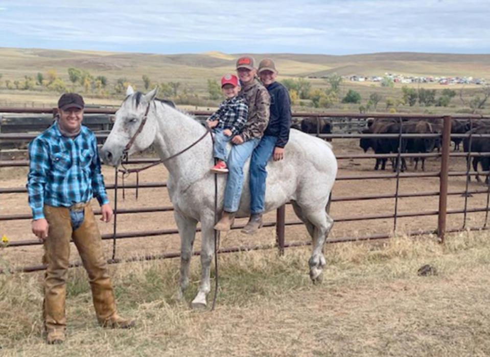 Zimbelman’s sons Mac, Mitch, and Myles were able to watch their dad at the buffalo roundup. (Photo courtesy of Sonya Zimbelman)