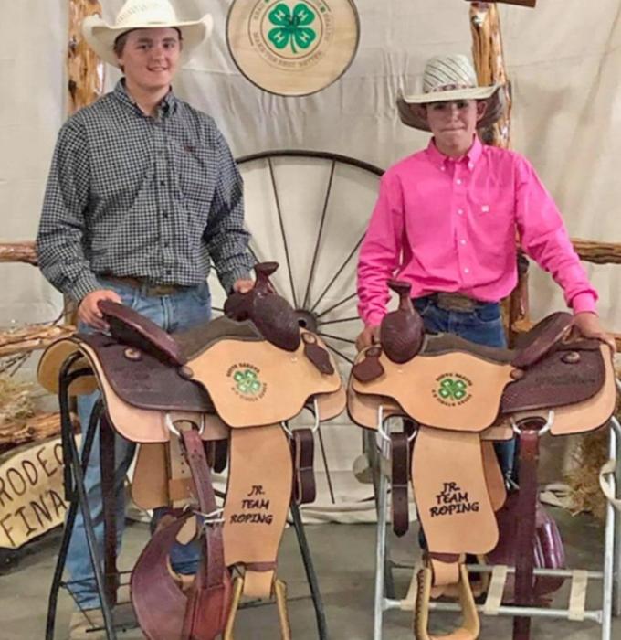Jayder Schonebaum and his partner, Rope Reis of Chamberlain, pictured with their saddles for winning the team roping.