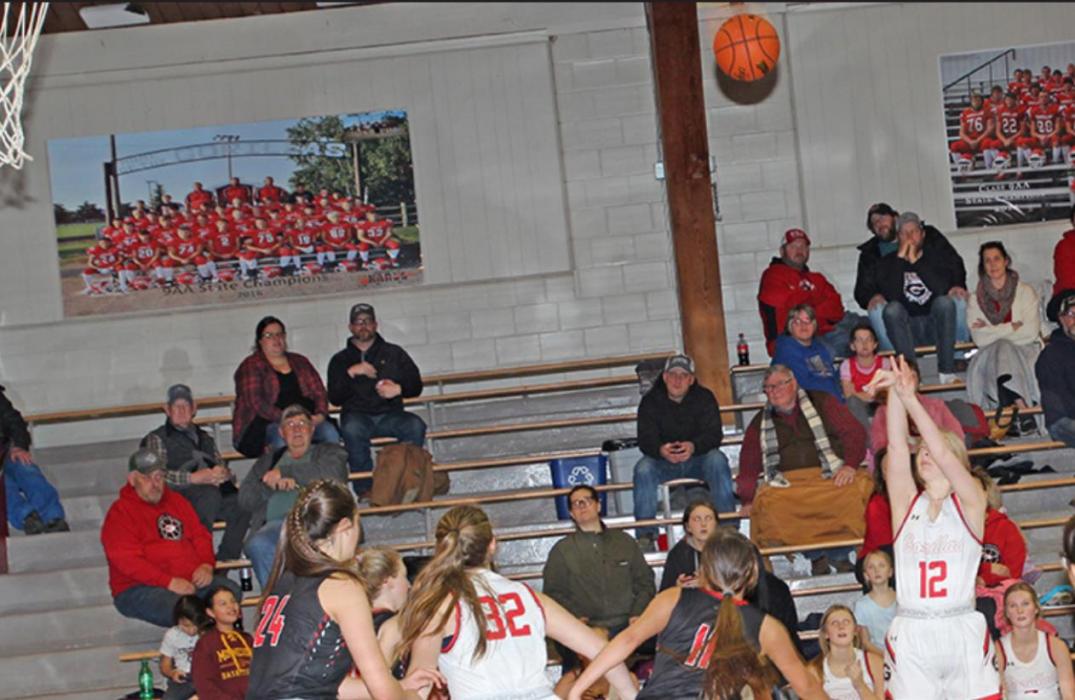 Jordan Svatos, #12, attempts a shot against Lyman defenders in Gregory’s 60-35 win at home.