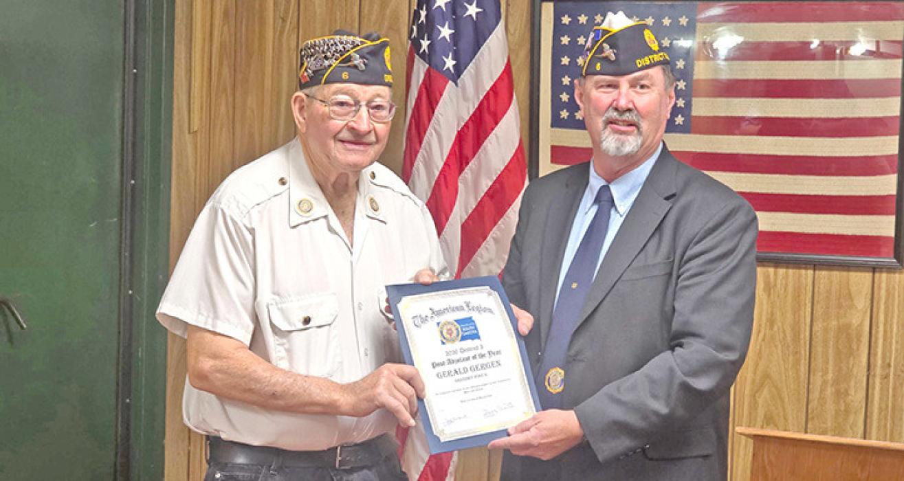 Gerald Gergen, l, receives an award from newly-elected District Commander Greg Smith (r) for his recognition as District 3 Adjutant of the Year.
