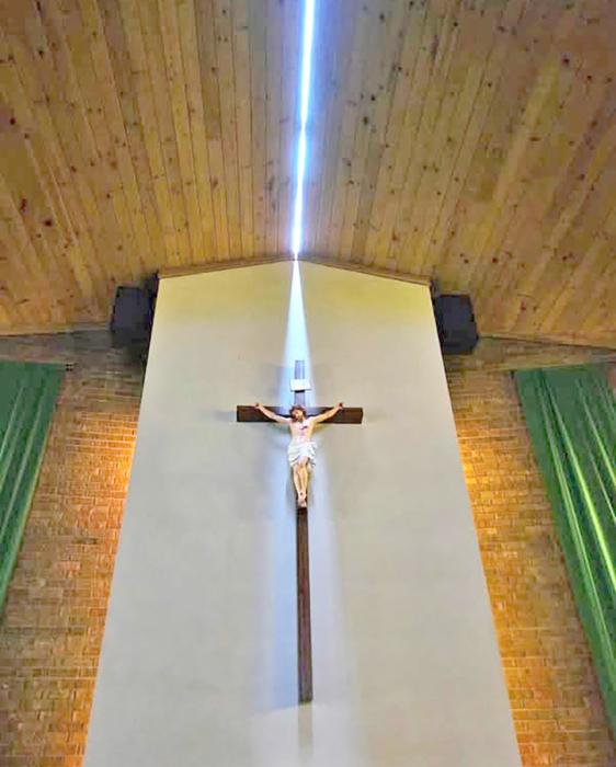 The light shining on the crucifix is sunlight creeping in through the roof at St. Mary’s Catholic Church in Highmore, SD, which was split in half during 130+ MPH winds on Monday, June 29, 2026. (photo by Joseph Mat/Hannah Ekwall TV Facebook page)
