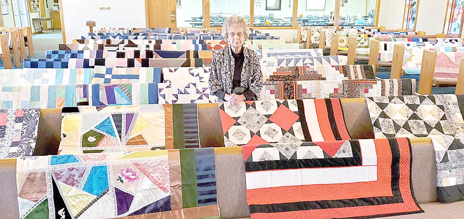 94-year-old Vlesta Schmidt stands amidst dozens of quilts she has made over the past couple decades recently, on display at St. John Lutheran Church. Her daughter estimates that she has made a total of about 170.