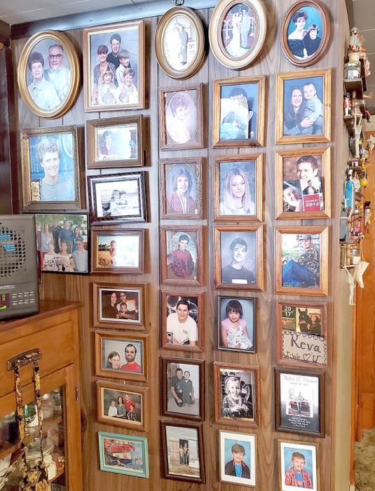 One wall is covered with photos of every member of her family.