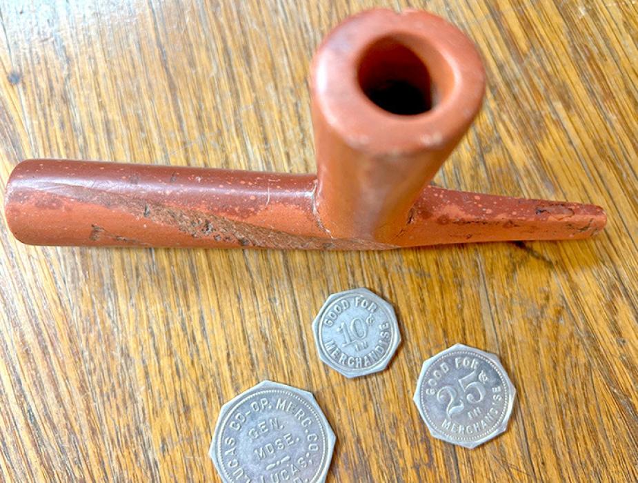 Items donated by the Petersons were tokens from the Lucas Co-op Mercantile Company and a Lakota Sioux peace pipe.