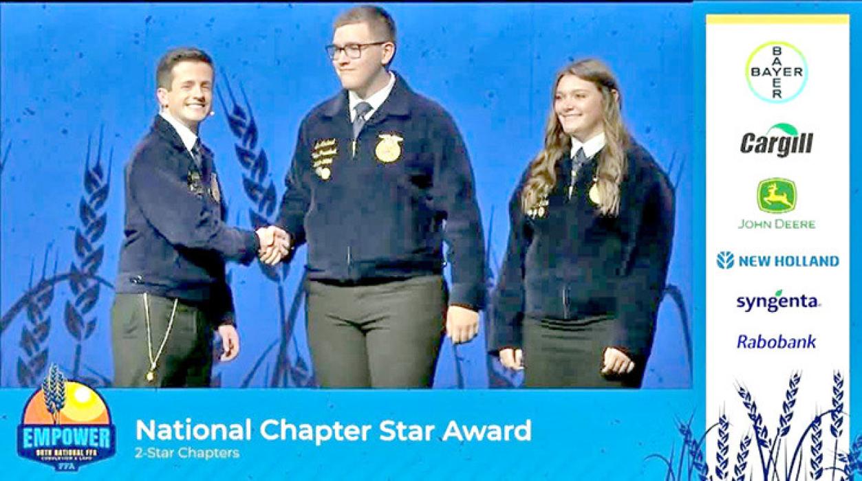 Leo Mostard, center, and Ava Kerner (r), two of the Gregory County FFA officers from 2024-25, accept the National 2-Star Chapter Award at FFA National Convention in Indianapolis, IN, recently.
