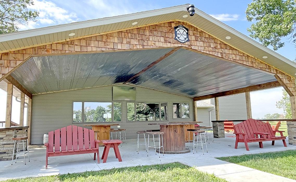 The sign for the entrance of the golf course and the 19th Hole Patio Bar were completed with funds from the Memorial Golf Tournaments, donations, and many hours of volunteer work.