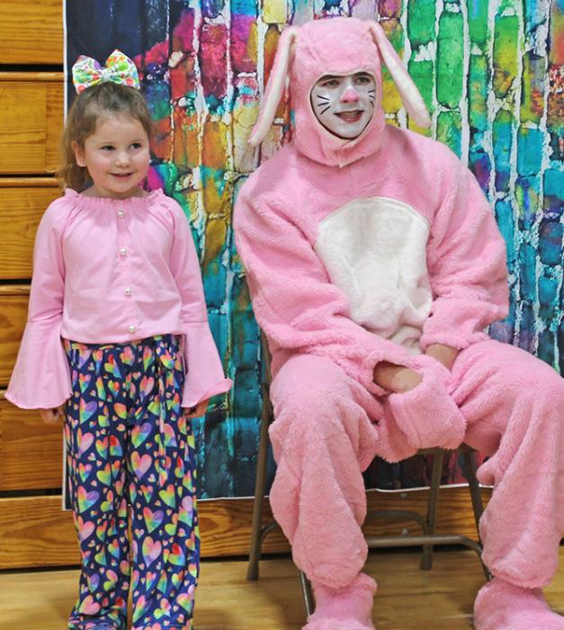 Miah Olson bravely stands near the Easter bunny for a photo.