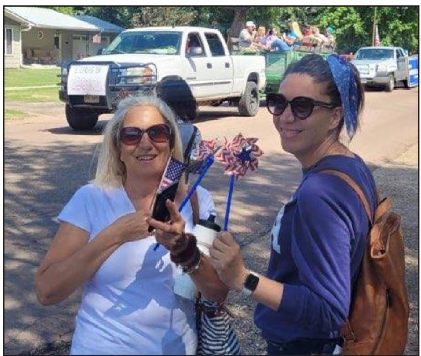 Patty Beck, a naturalized United States citizen from Malaga, Spain, is shown here (r) with her mother at the parade with their stars and stripes pinwheels.