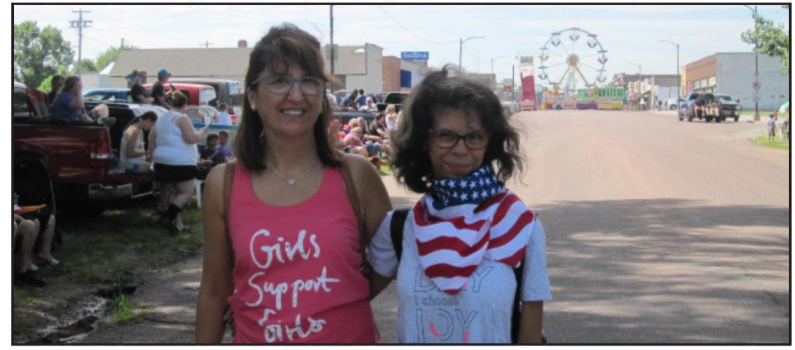 Patty’s aunt Maria and cousin Sara watched the parade from their spot north of the carnival on Main Street. They enjoyed the candy, all the American stuff, veterans, flags, and horses.
