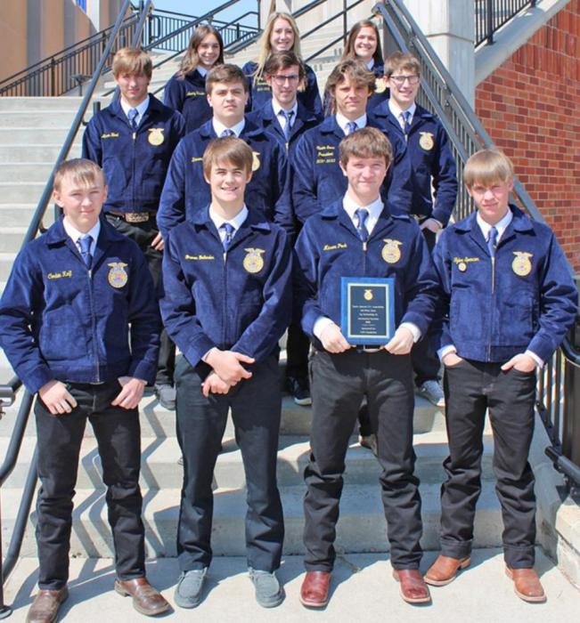 The twelve members who participated in the state competition show off the ag mechanics team’s hardware.
