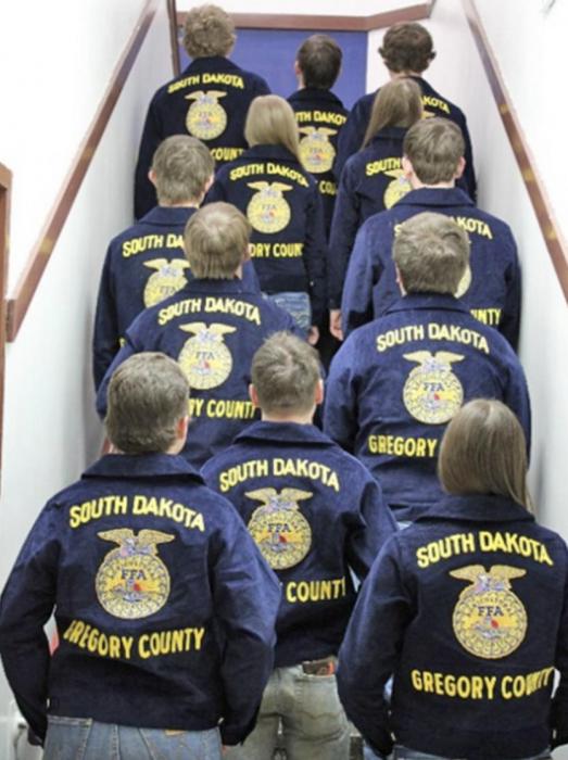 Members pose for a photo shoot with their new jackets.
