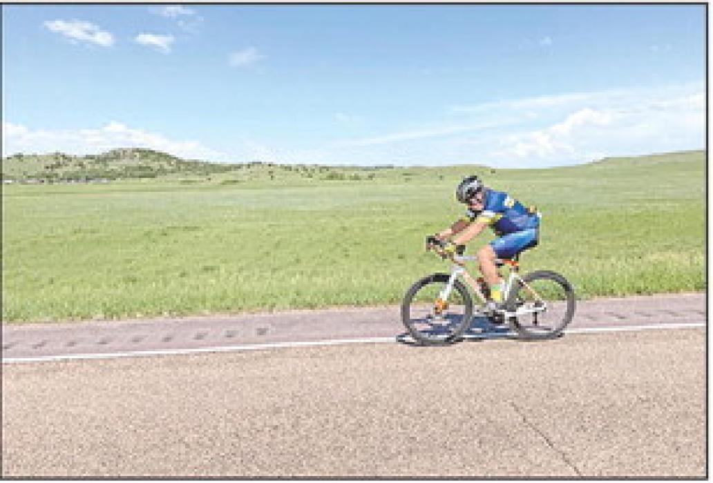 A lone cyclist travels down Highway 47 near the Lyman/ Gregory County border. (Photo by Heather Hammerbeck)