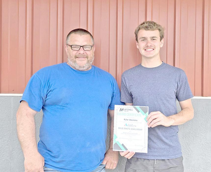 Bryan Witt, l, of the Building Center, and Ryler Stevicks have partnered to fill a high-demand job in the community through the Build Dakota scholarship program.