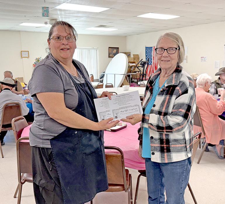 May is National Beef Month, a time to recognize and honor the ranchers, farmers, and producers who dedicate their lives to raising high-quality American Beef. Deana Nelson is shown here presenting two beef certificates to Bernadine Holmberg of ROCS Dining Services on behalf of the Rosebud Rancherettes.