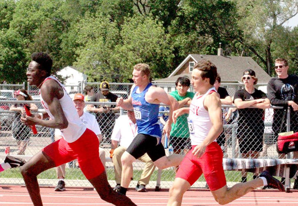 Daniel Mitchell takes a hand-off from Luke Stukel in the 4x200 relay. He stepped up to fill in for Kade Stukel, who suffered a hamstring pull the day before. (Photo by Dan Bechold - Winner Advocate)