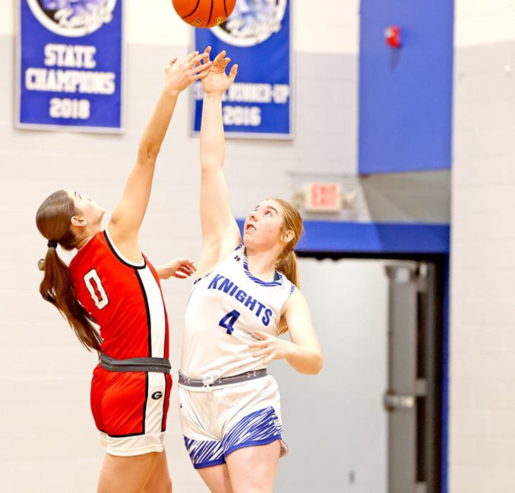 Dani VanDerWerff stretches high to outreach a Springview player.... Colt
