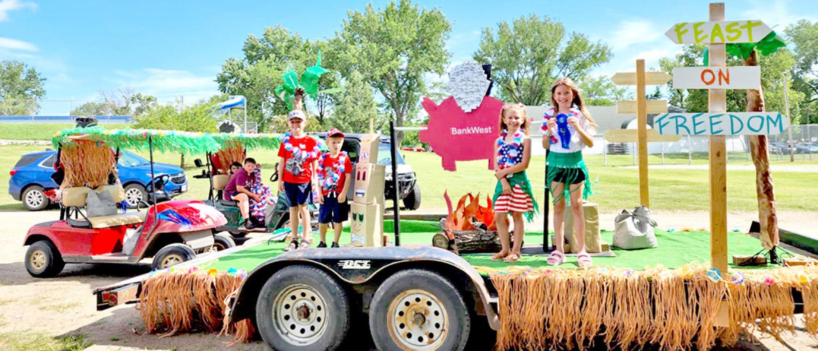 Even the trailer had a grass skirt on BankWest’s piggy bank hog roast float that won first place in the Business division.