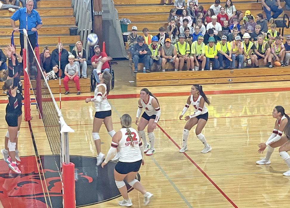 Adelyn Veskrna attempts to score over the opponent’s double block. (Photo by Kristi Ring)