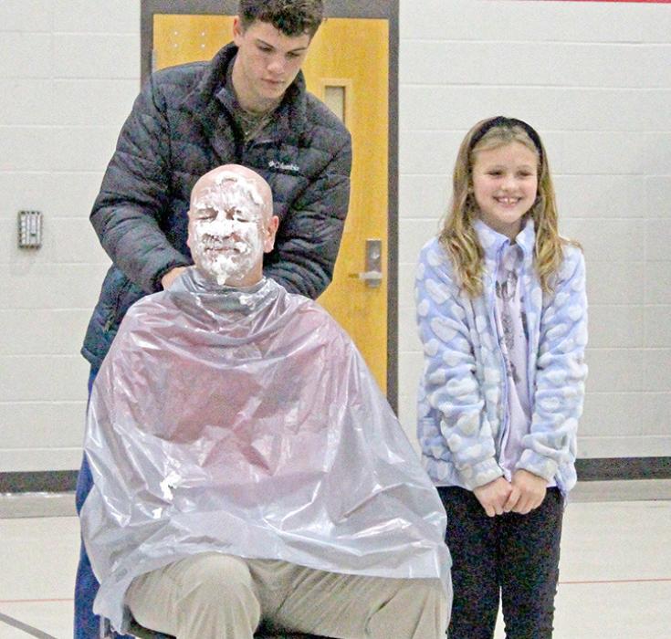 Principal Jeff Determan received a pie in the face, compliments of top fundraiser Claire Jacobsen, for the first $1,000.