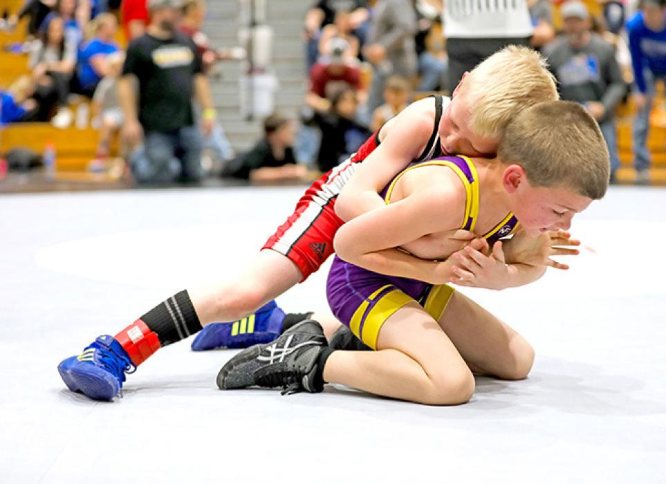 Alex Wenger, at 53 pounds in the 8U division, works his opponent on his way to a first place finish. (Photo by Bailey Veskrna)
