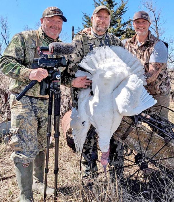Greg Cherne, center, poses with his guide Alex Rutledge of American Roots Outdoors, l, and Neil Hylla, r, of Rock Road Outfitters, and the rare double-bearded albino turkey he shot in Gregory County.