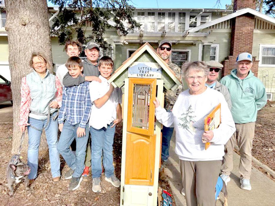 Francie Johnson, front, is here with her whole Little Free Library crew, shown l to r: Stephanie Pochop, Cullen Verville, George Johnson and sons Nicholas and Fielding, Matt Frank, Doug Pochop, and Scott Anshutz.
