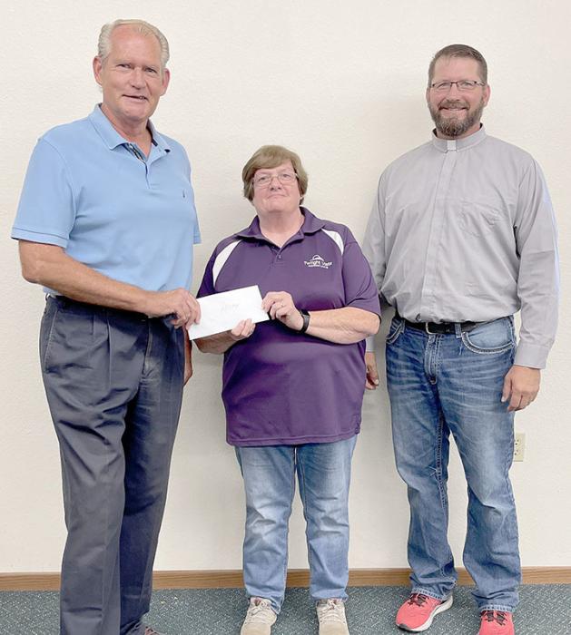 Each year St. Joseph Catholic Church makes donations to charities or entities that provide a needed service for our community. This year, Parish Council President Joe Duling, left, and Deacon GW Ekroth, right, presented a check to Dawn Boyer of Hilltop Drive-Inn Theater.