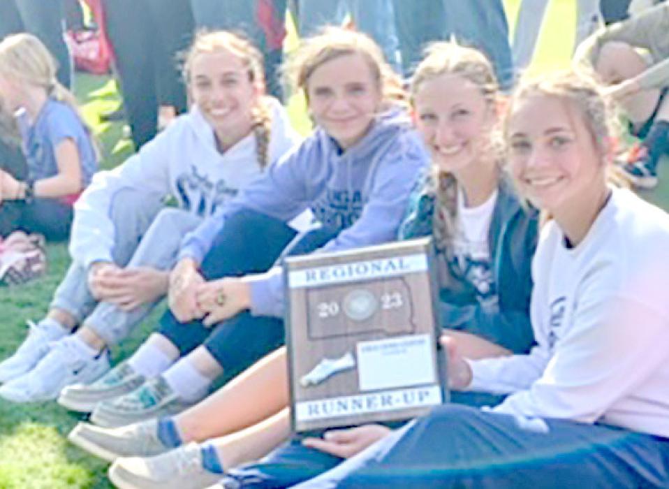 Avery Zeisler poses with her cross country team after qualifying for the state meet. Zeisler qualified as an individual by placing 10th, and the team qualified with its second-place finish.