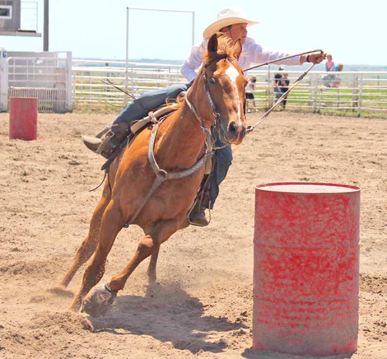 Mckinley Peppel maneuvers around a barrel for 3rd purple in the junior division of barrel racing.