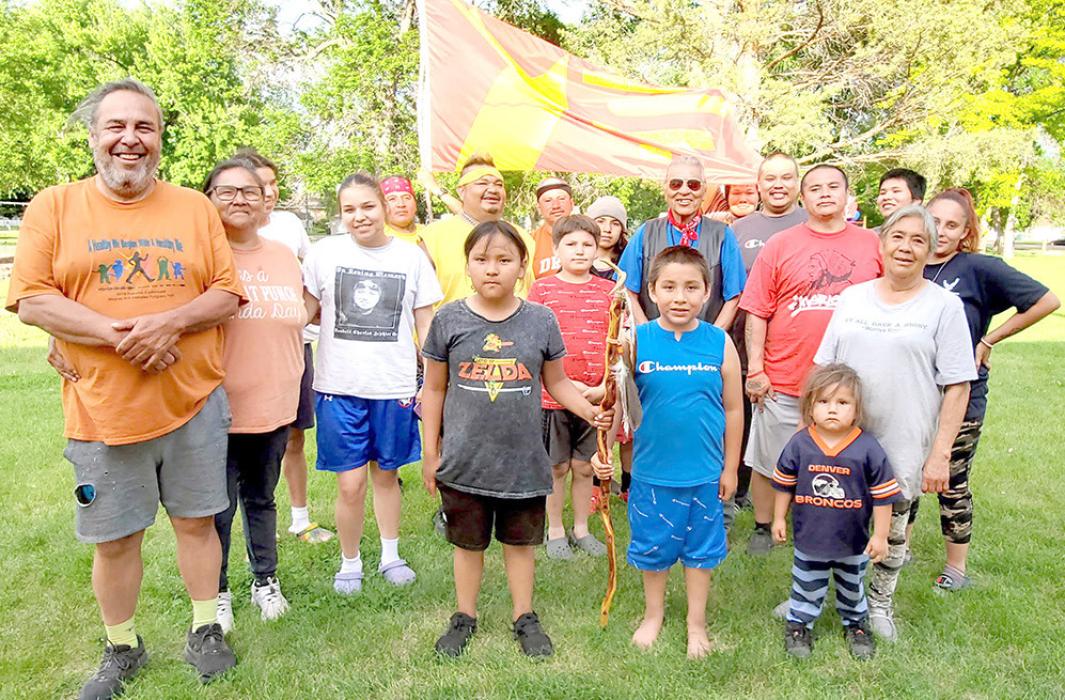 The runners who completed the leg into Gregory and the first part of the leg to Mission are shown here. The staff, with three eagle feathers, representing the Santee, Ponca, and Yankton Sioux tribes is held by two youths in front. Each tribe that participates will add a feather, for a total of nine feathers by the end of the run.