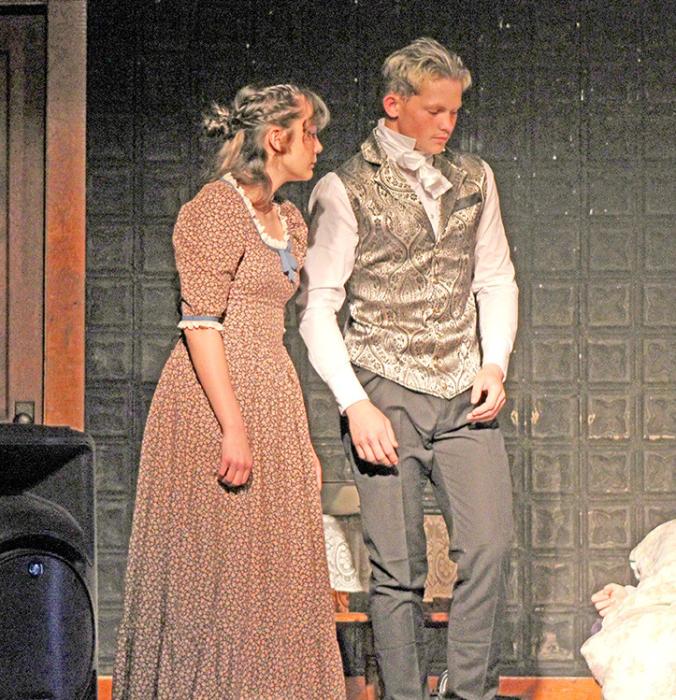 The Doctor (Mason Janak, r) discusses the ailing Marianne with sister Elinor (Piper Bartlett, l). (Photo by Hayden Odegard)