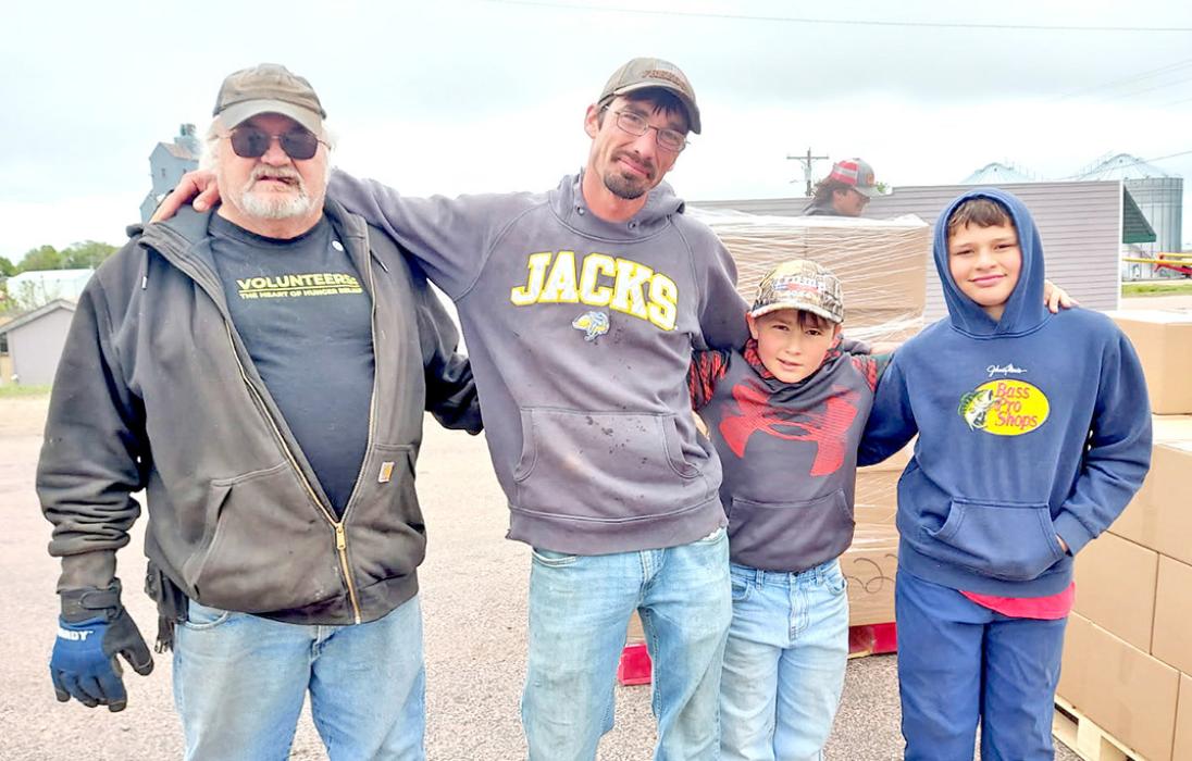 Three generations of the John Vosika family recently helped distribute food for Feeding South Dakota in Gregory. Shown left to right, they are John, Melvin, Jace, and friend Tate Reinartz.