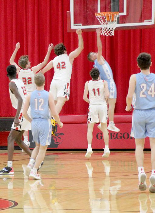 Where’s the ball? Players from both teams take to the air for a rebound in Gregory’s game against Bon Homme Friday night. The Gorillas’ win earned the team a share in SESD conference title. (Photo by Gracie Stephens)